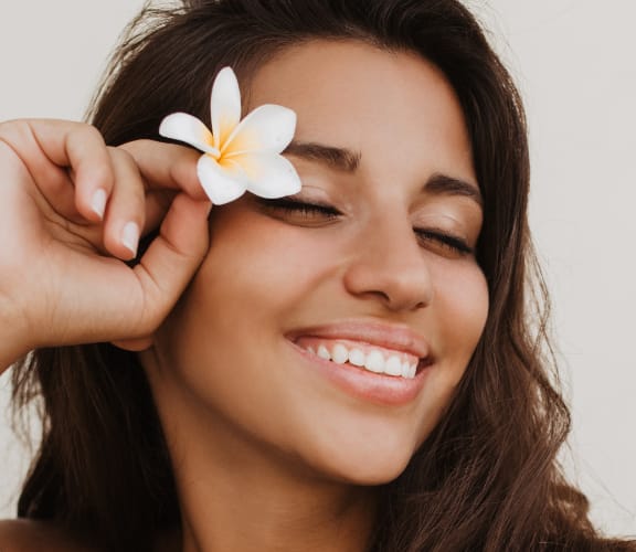 Woman holding a flower in her hair
